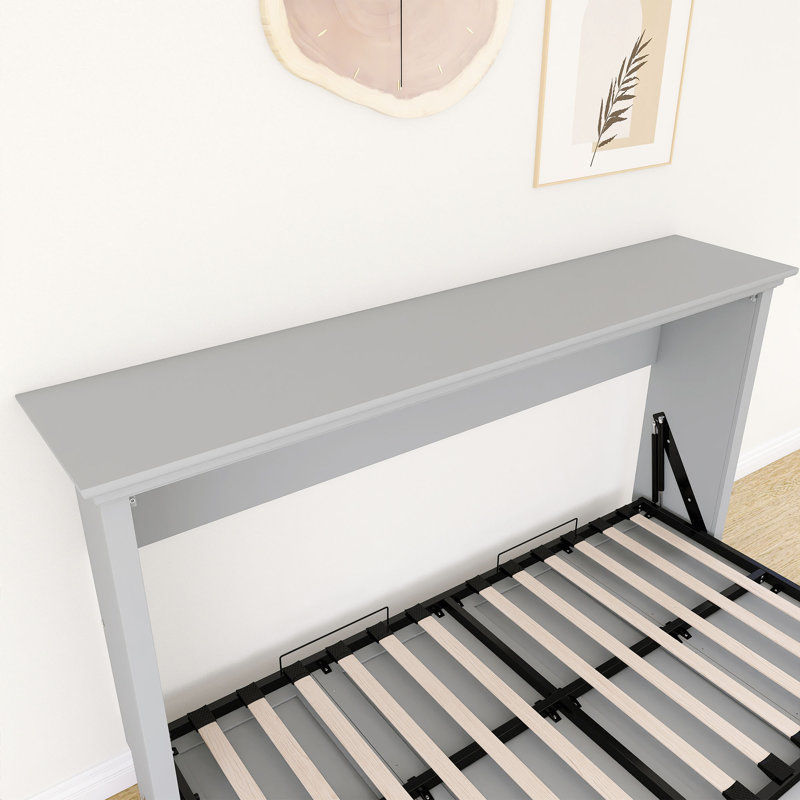 Lit escamotable gris de taille simple, peut être plié dans une armoire