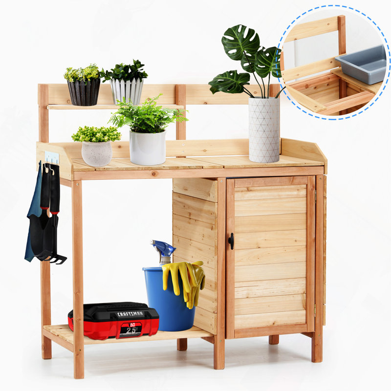 Table de rempotage extérieure en bois avec évier intégré et tablettes de rangement