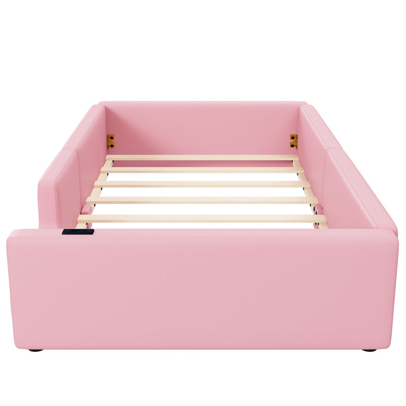 Lit plateforme simple tapissier rose avec station de charge et garde-corps