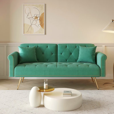 A 69.7-Inch-Long Sofa Bed Covered In Green Velvet Fabric, Featuring Nail Head Trim And Accompanied By A Matching Throw Pillow