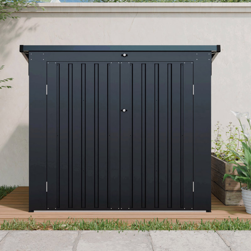 La remise à poubelle peut contenir 2 poubelles en métal