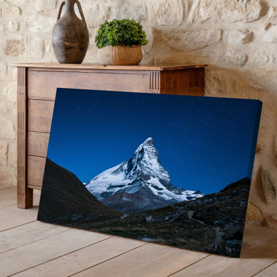 Canvas A Majestic Snow Capped Mountain Rises Prominently Against A Deep Wall Art Blue Night Sky Dotted With Countless Stars And A Canvas Wall Art