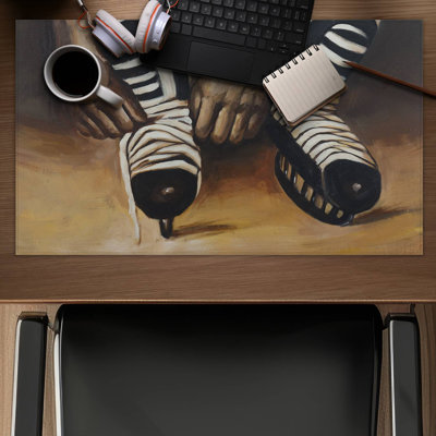 Hockey player ties his skates - 14.00"x24.25" Desk mat