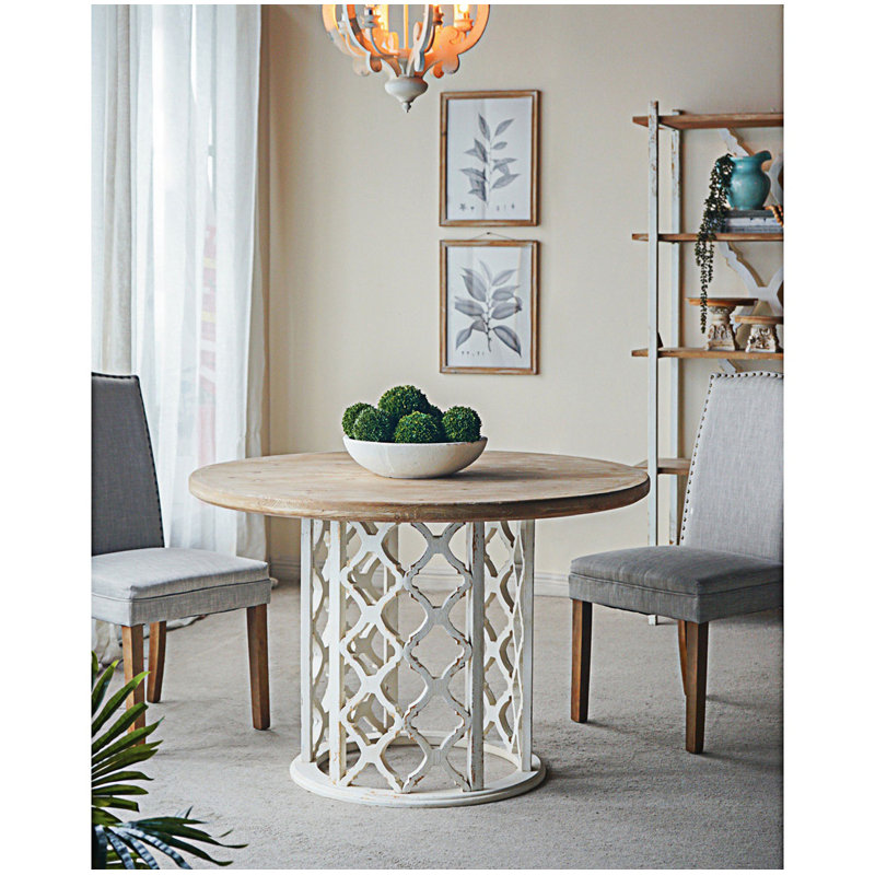 Table de salle à manger ronde avec base découpée ornée