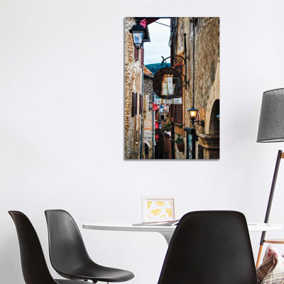 Étroit rue médiévale avec signes et lampes, Sermoneta, Italie par George Oze - reproduction de photo sur toile tendue