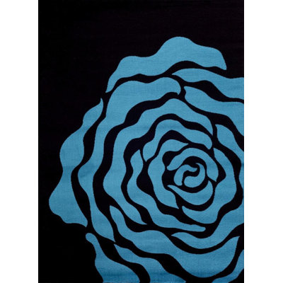 Tapis turquoise / noir à motif floral