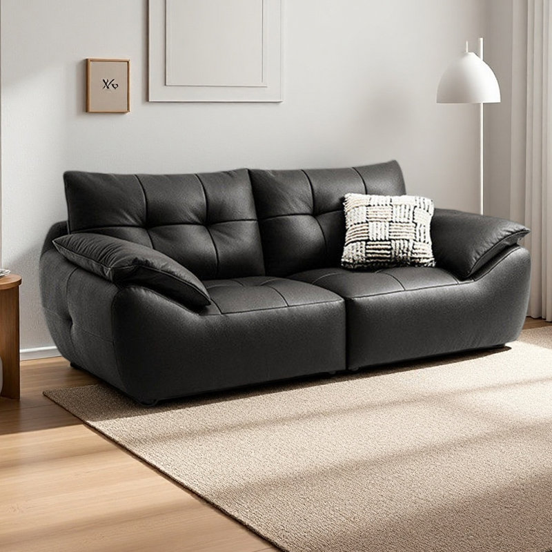 Causeuse-coussin modulable noire en cuir véritable