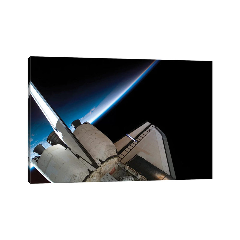 Space Shuttle Endeavour Backdropped By Space And Earth's Horizon by Stocktrek Images - Wrapped Canvas Print