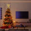 Noël et le sommet de l'arbre en fer forgé brillant, étoile d'ange, or, avec lumières