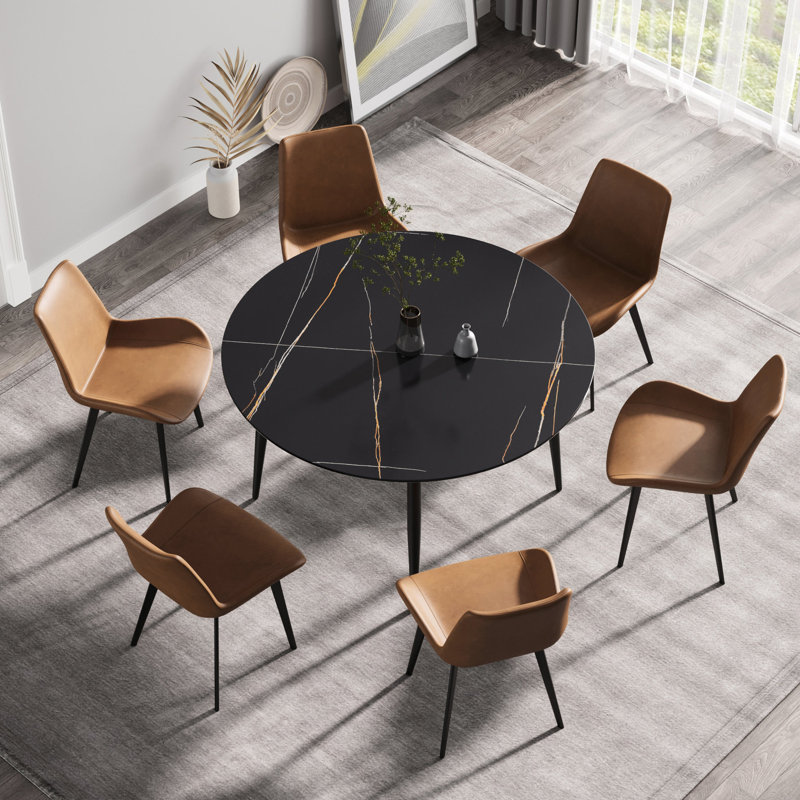 Table ronde à pieds en métal noir avec dessus en pierre frittée durable pour 6 repas