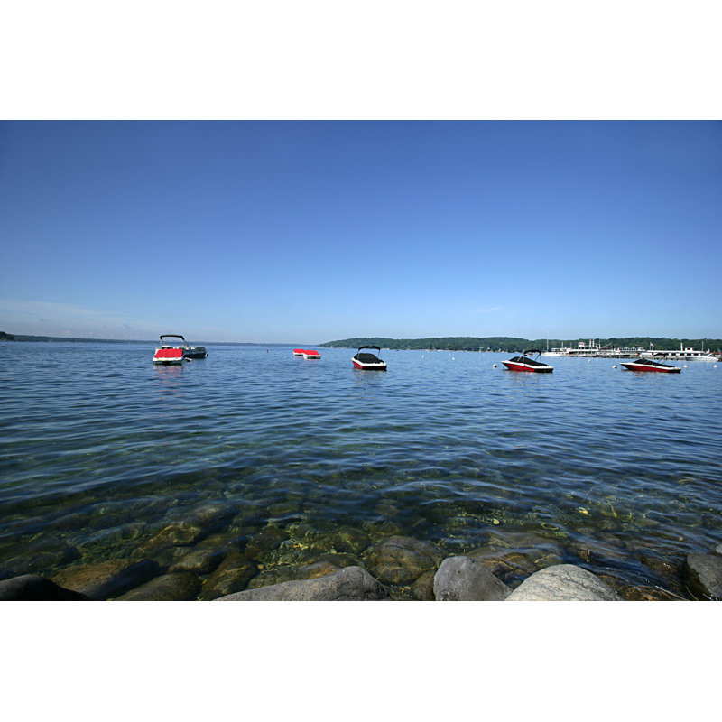 Several speedboats dock on the waters of Lake Geneva, 30cm H x 46cm W