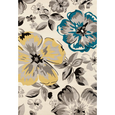 Tapis performance crème / jaune / bleu à motif floral moderne