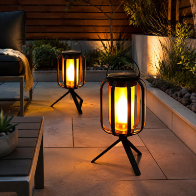 A waterproof outdoor solar lantern creates a realistic Flickering Flame and comes with a Tripod, supporting Solar and USB-C Charging plus 4 Light Modes for Hanging, Tabletop, or Tripod use as garden decor in yards, patios, or camping.