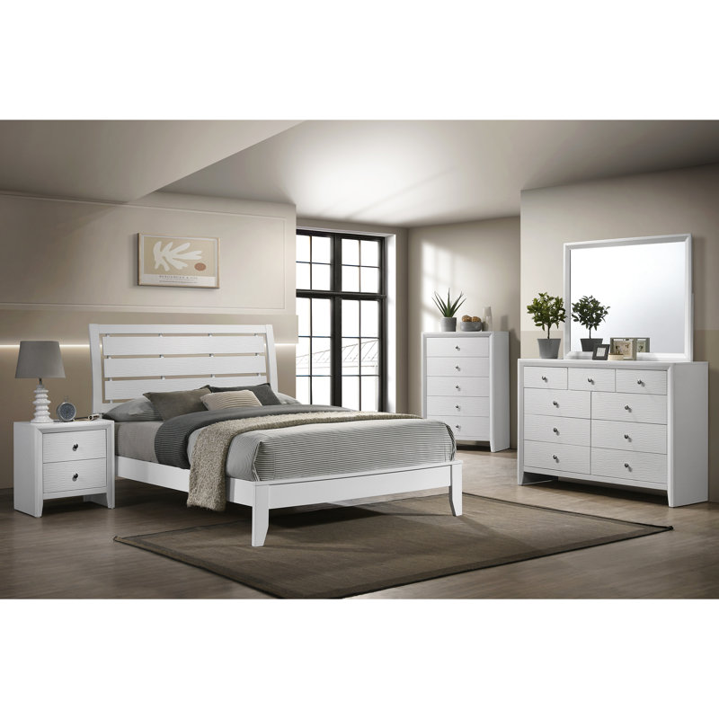 Grand lit blanc avec cadre géométrique et profil bas pour une chambre de style avec des pieds de soutien de forme géométrique.