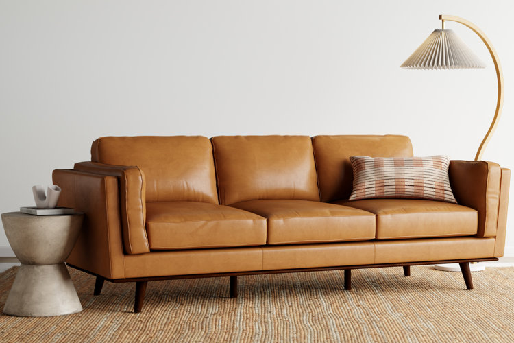 leather mid-century modern sofa with a checkered throw pillow