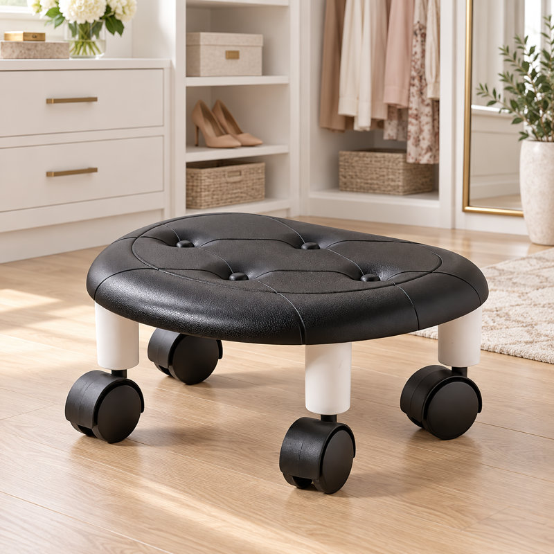 Tabouret bas à roulettes avec assise rembourrée en similicuir