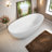 65" Matte White Freestanding Stone Resin Bathtub, 57.63 Gallons Capacity, Ergonomic Design With Center Drain, Overflow, Easy Maintenance,Pre-Installed Drain