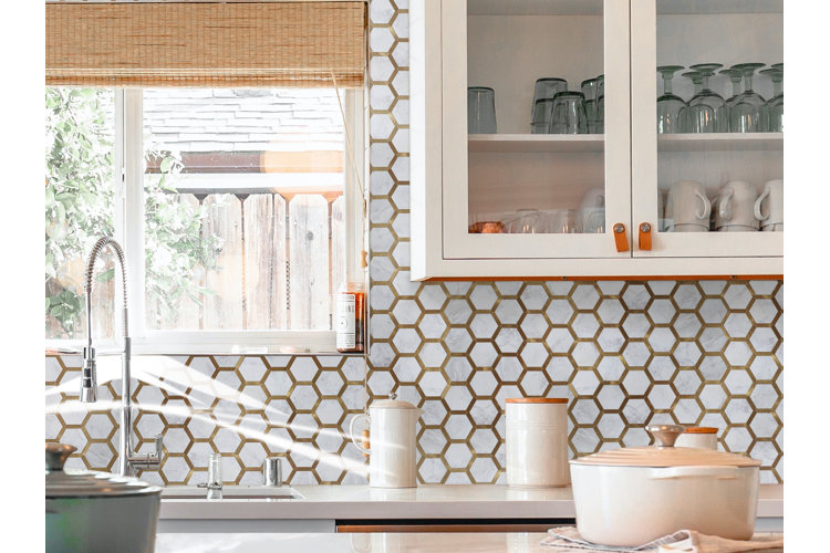 beautiful white and gold honeycomb peel-and-stick backsplash over the sink in a modern kitchen