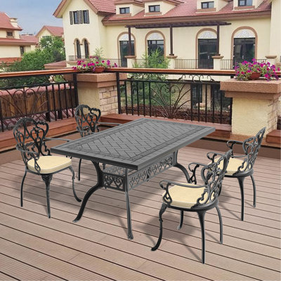 Set Of Cast Aluminum Patio Furniture With Black Frame And Off-White Seat Cushions