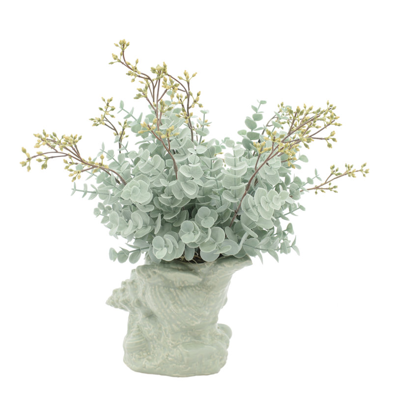 Eucalyptus Arrangement In A Shell Vase.
