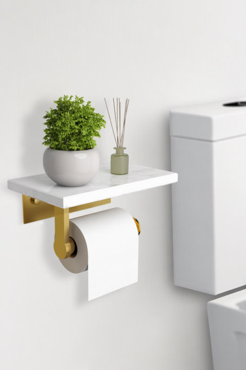 Wall-mounted toilet paper holder with a white marble top shelf and gold metal accents, holding a roll of toilet paper beside a bathroom vanity.