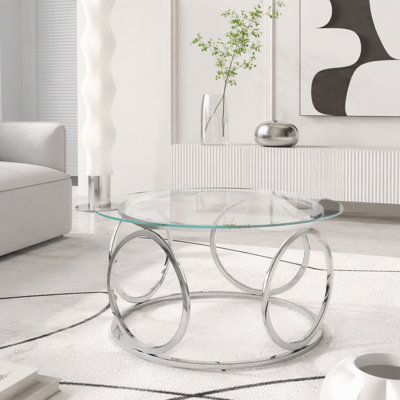 Table basse moderne à plateau rond en verre avec structure circulaire en métal