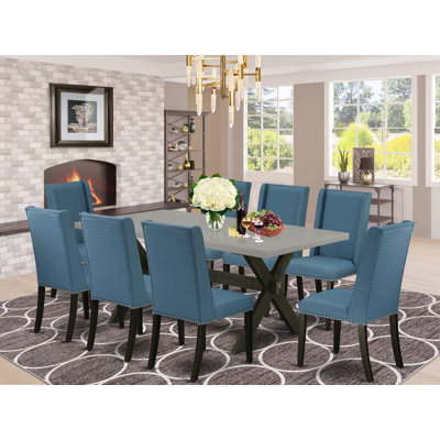 Ensemble de table de salle à manger 9 pièces moderne comprenant une table de salle à manger rectangulaire avec pieds en X et 8 chaises Parsons en tissu bleu, finition noire brossée