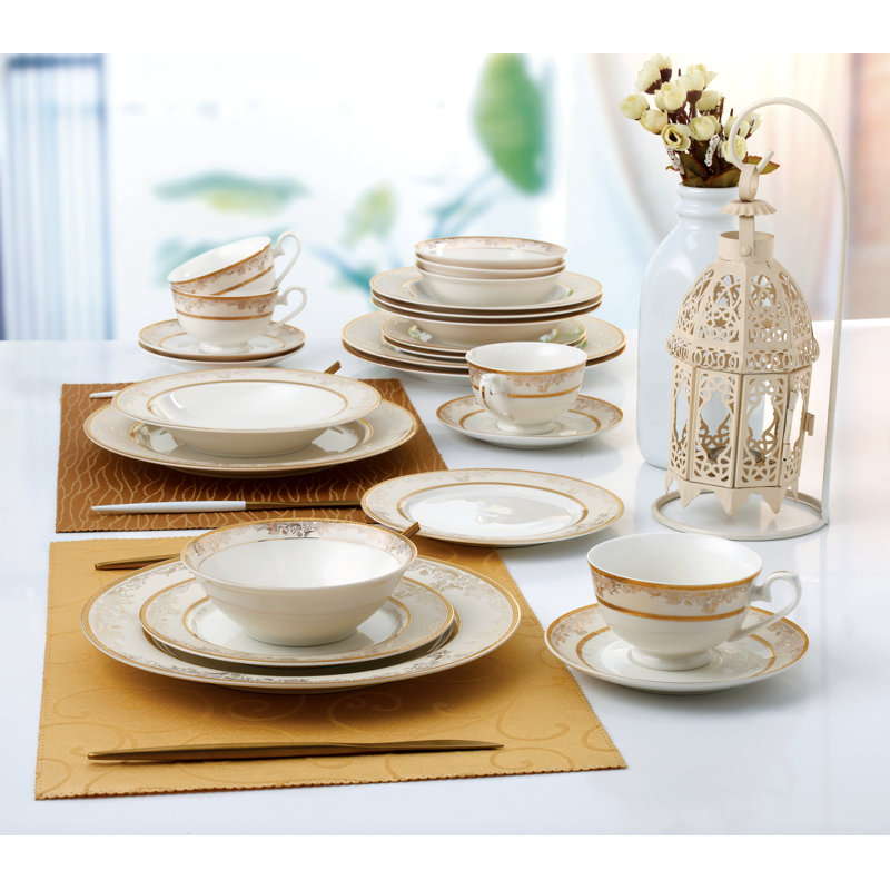 A 24-piece set of China dinnerware on a table