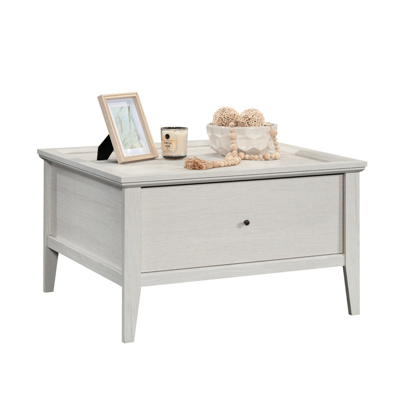 Table basse grise avec une finition latérale, un motif hexagonal et une surface amplement indispensable