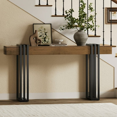 Walnut-Finish Wooden Console Table With A Black Parallel Metal Frame And Built-In Power Outlets. It Can Be Placed Behind A Sofa, In A Hallway, Living Room, Or Entryway, Making It Ideal For Various Spaces.