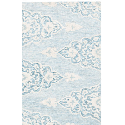 Tapis en laine / coton touffeté à la main ébène en ivoire / bleu clair