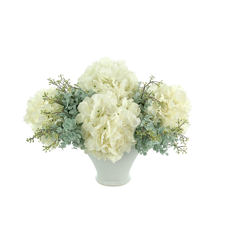 Hydrangea And Seeded Eucalyptus Floral Arrangement In A Round Ceramic Vase