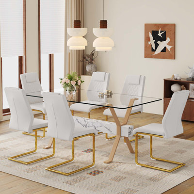 Ensemble de table et de chaises. Table de salle à manger élégante en verre trempé transparent - 71 po x 35,4 po avec chaises en polyuréthane de haute qualité avec pieds en métal arqués. Grande table avec pieds en métal en forme de X.