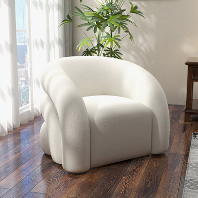 Fauteuil demi-tonneau pivotant rembourré Coyle