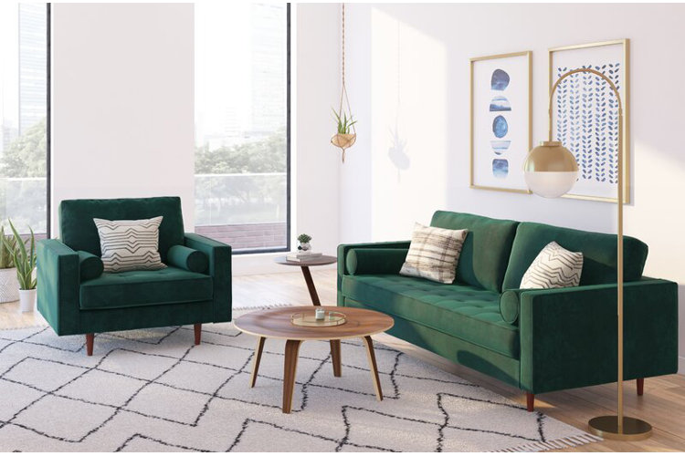 White living area with velvet green sofa and accent chair.