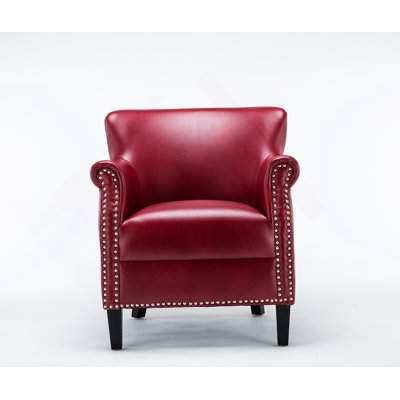 Luxueux fauteuil club avec un tissu souple semblable au cuir et une finition cloutée matte classique, combinant confort et élégance pour tout espace de vie.