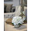 White Hydrangea Arranged In A French Labeled Glass Vase