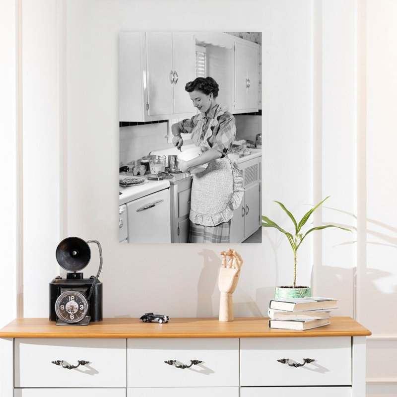 1950s WOMAN HOUSEWIFE IN KITCHEN APRON MIXING BAKING INGREDIENTS IN BOWL by H. Armstrong Roberts - Wrapped Canvas Print