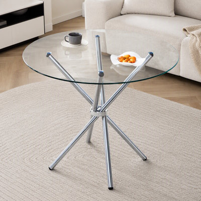 Table de salle à manger ronde en verre transparent, forme unique, pour 4 à 6 personnes, pieds en métal argenté en forme d'anneau, adaptée à de nombreux espaces.