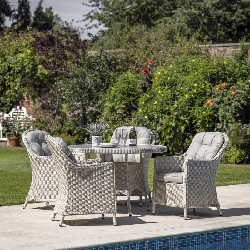 Abigail 4 - Person Patio Dining Set with Round Table , Cushions Included