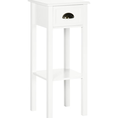 Table d'appoint blanche avec tiroir. Offre un espace de rangement supplémentaire pour les livres et les photos. Élégante et pratique pour une chambre ou un salon. Construction robuste et stable. Anti-basculement. Étagère inférieure élevée pour une protection optimale contre les éclaboussures d'eau.