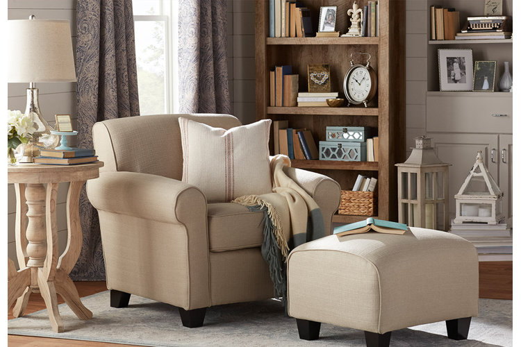 neutral living room with armchair and bookshelves
