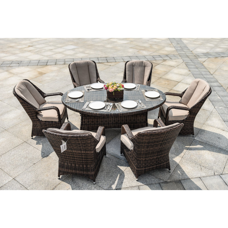 Silas 6 - Person Wicker Patio Dining Set with Oval Table , Cushions Included, Brown