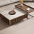 A mid-style walnut-colored coffee table set