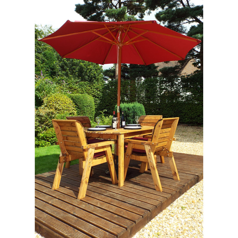Feldman 4 - Person Solid Wood Patio Dining Set Umbrella Hole Included Rectangular Table with Cushions Included, Burgundy
