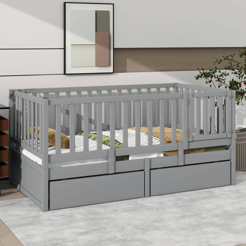 Lit de jour simple en bois avec garde-corps en forme de clôture pour la sécurité et deux tiroirs intégrés pratiques pour le rangement