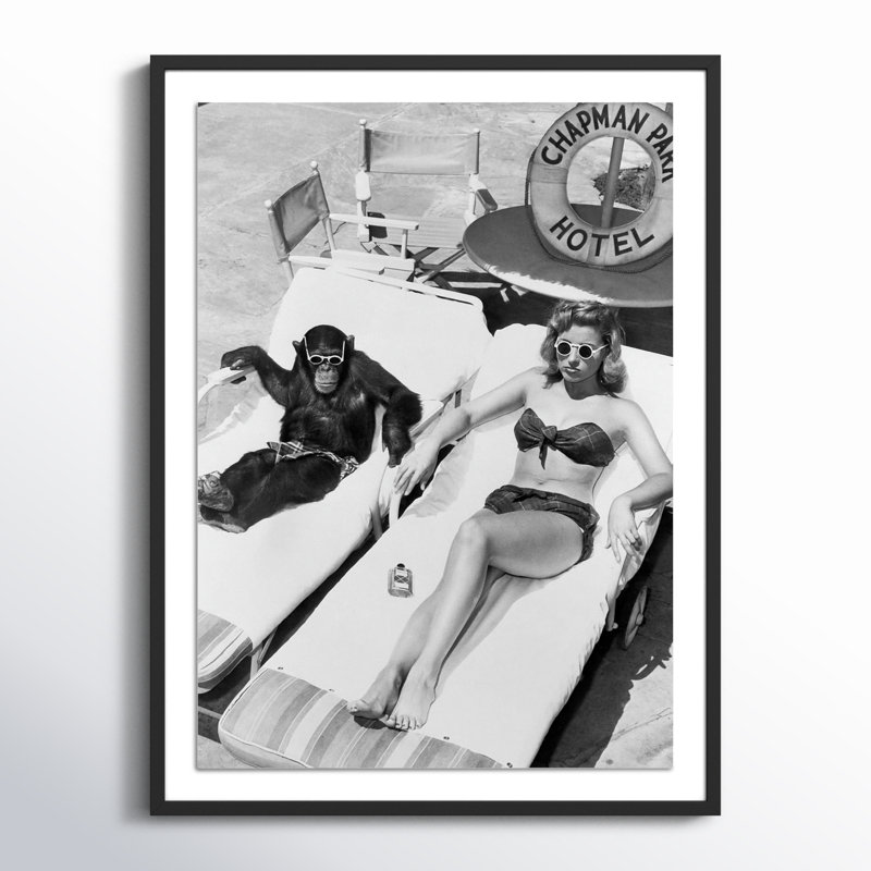 Woman Sunbathing With Chimpanzee by Getty Images, 32" H x 24" W, Black Maple Framed