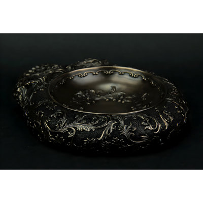 Plat en polyrésine bronze antique de style gothique, représentant un crâne humain orné de volutes florales, 23,5 cm de large