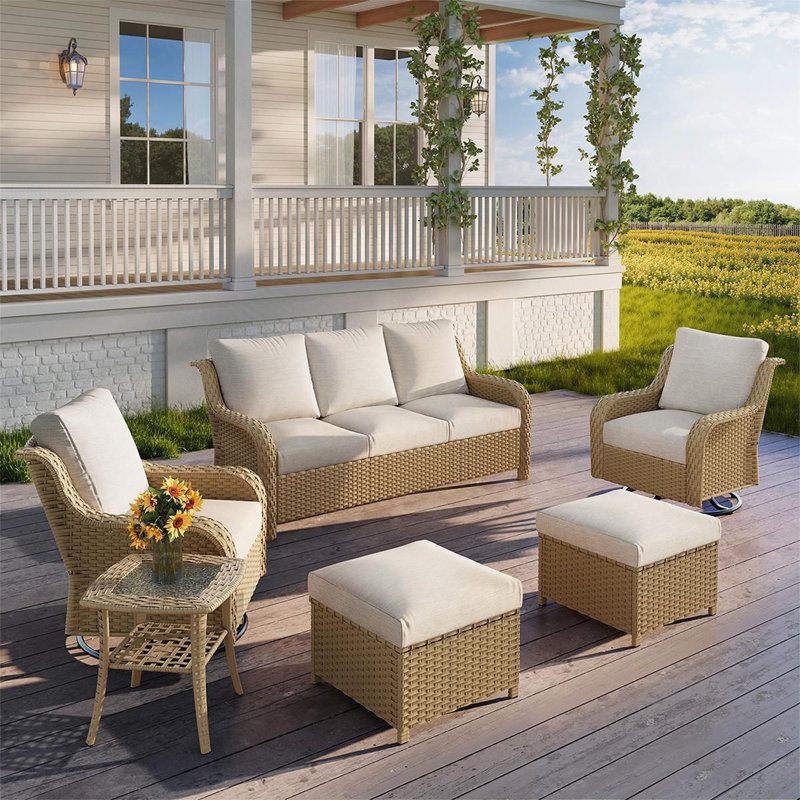 A Three-Seater Sofa With Two Swivelchairs With Two Footstools With One Table
