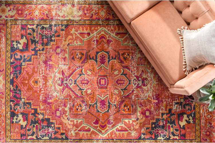 Overview of a russet oriental rug under a sofa